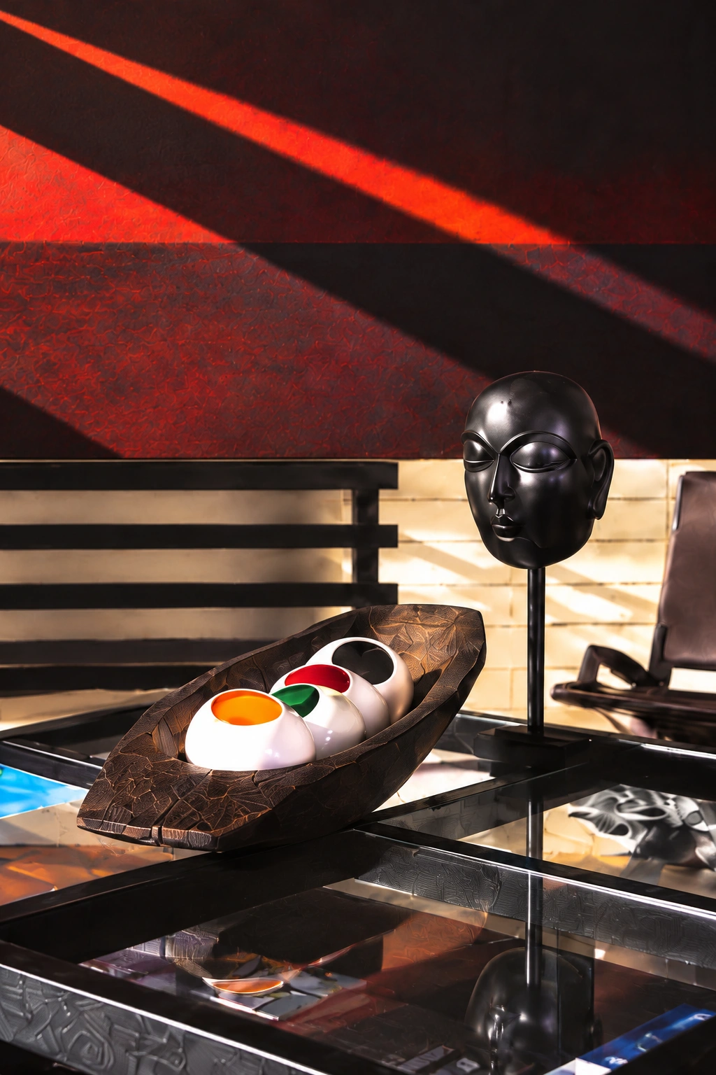 Sculptural black head and colorful vessels at Alexander Unwrapped