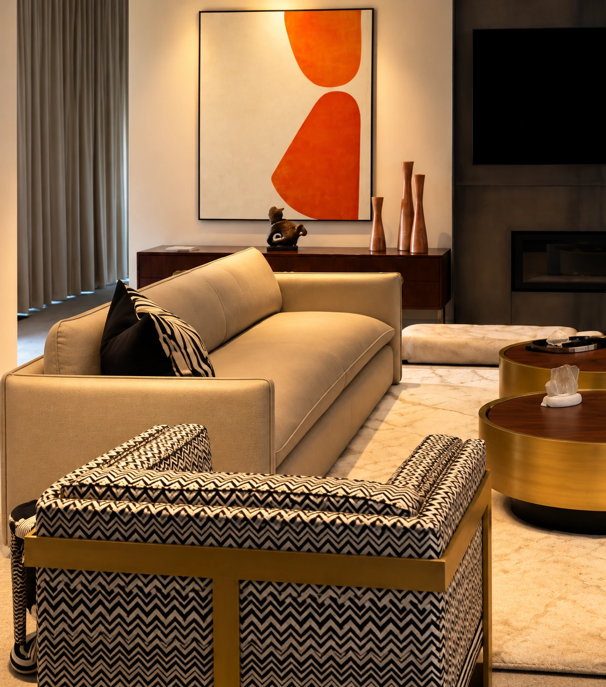 Orange artwork, patterned chair and brass tables at Palm Springs Men’s Retreat