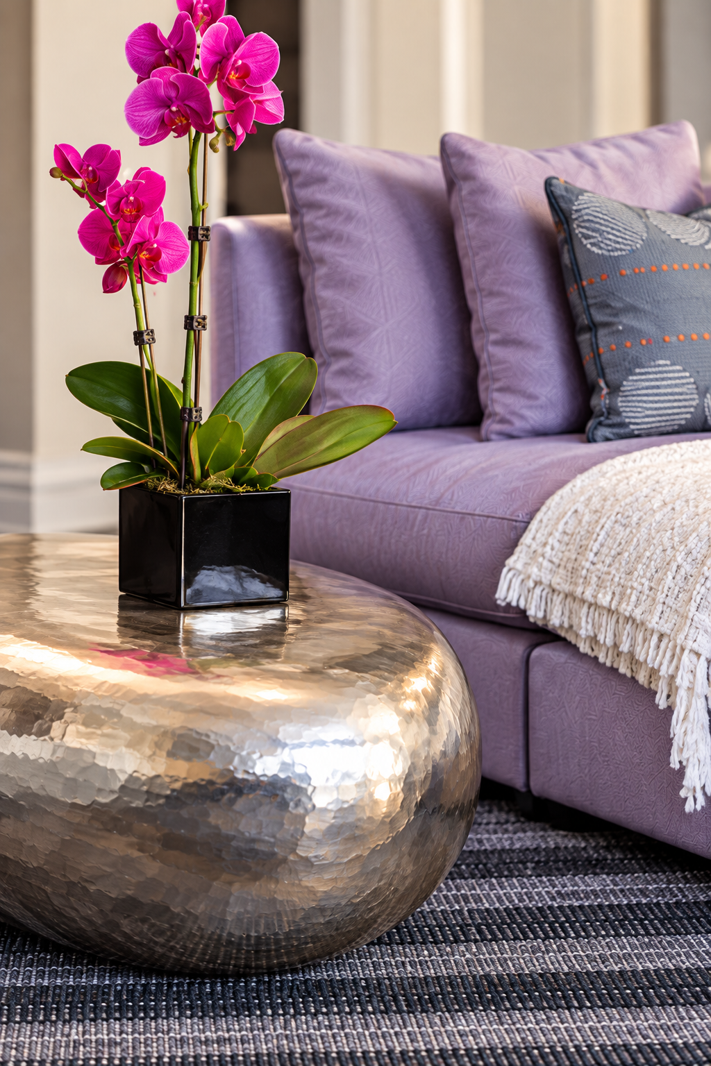 Magenta orchid, silver coffee table and lavender sofa at Santa Fe Residence