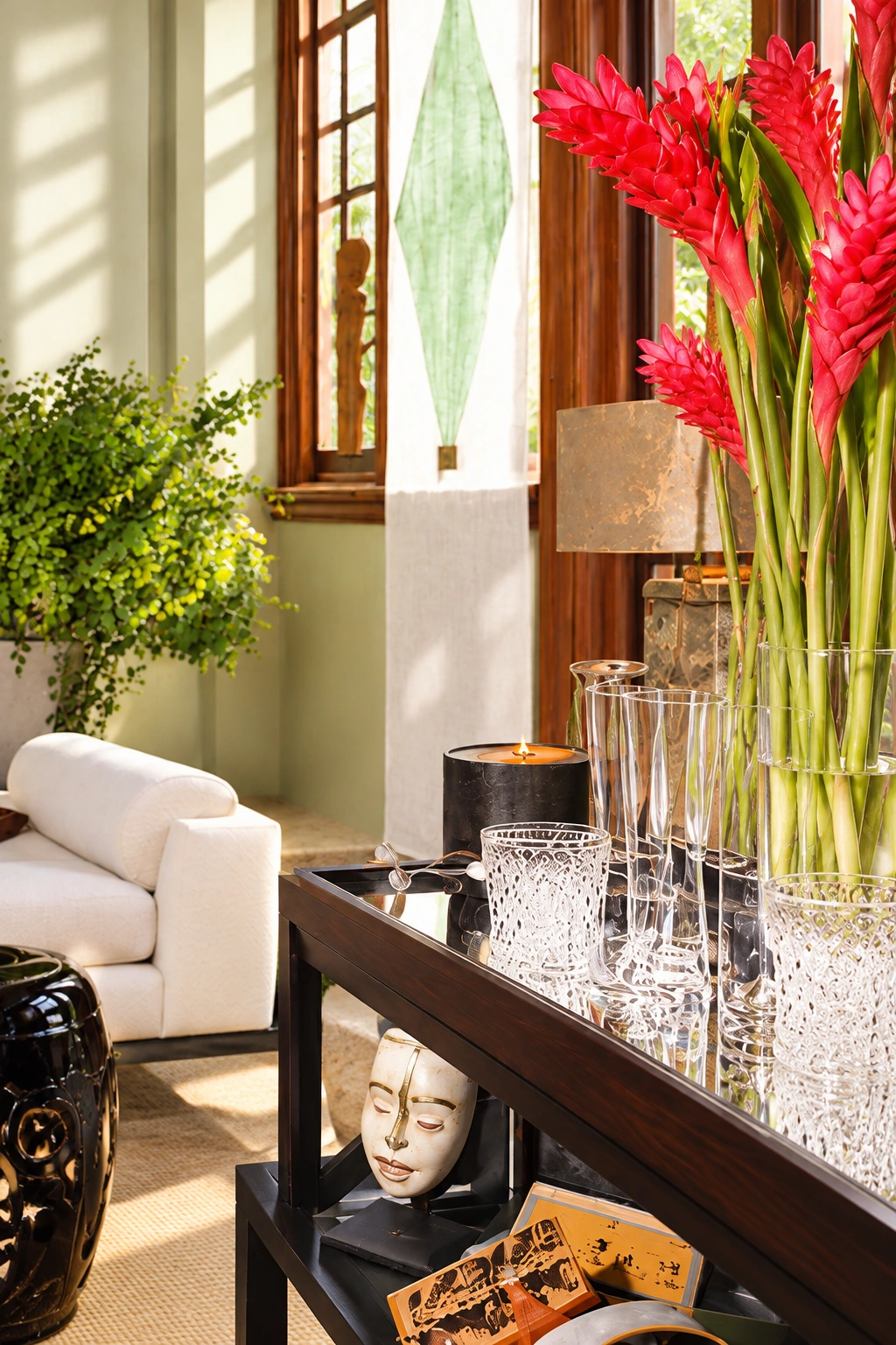 Red flowers and glassware on the showcase house drinks tray